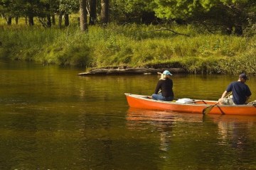 a group of people in a small boat in a body of water